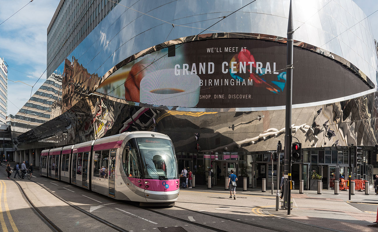 Metro tram passing Grand Central in Birmingham city centre, near to Bank House offices